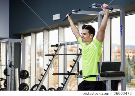 Young fit man wearing sportswear training at the gym Young fit man wearing sportswear training at the gym 36603473