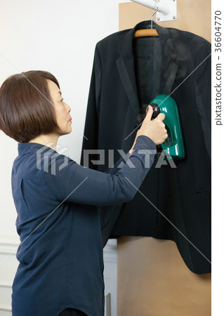 Women doing steam ironing Women doing steam ironing 36604770