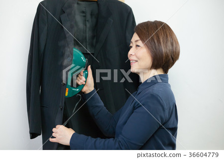 Women doing steam ironing Women doing steam ironing 36604779