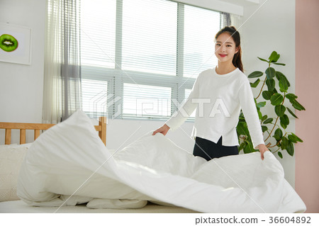 Young woman in twenties cleaning in bedroom Young woman in twenties cleaning in bedroom 36604892