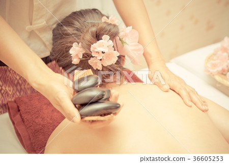 Woman is getting Hot stone therapy in Spa Woman is getting Hot stone therapy in Spa 36605253
