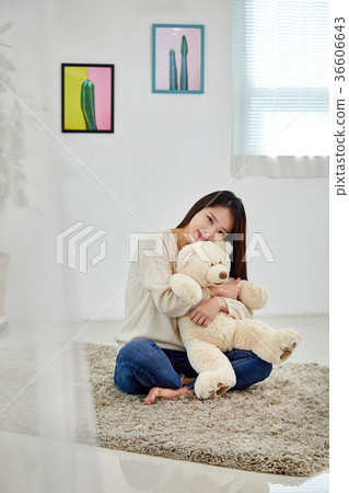 A young Korean woman in her 20s who is happy with a doll 36606643
