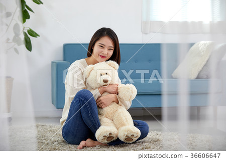 A young Korean woman in her 20s who is happy with a doll 36606647