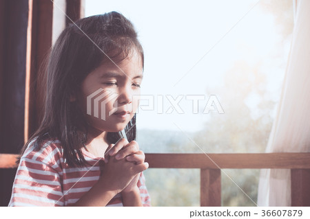 asian child girl praying with folded her hand asian child girl praying with folded her hand 36607879