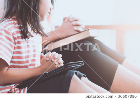 child girl and her mother praying with folded hand 36607880