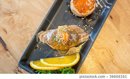 Fresh salmon eggs sushi on a black plate (Japanese food). Fresh salmon eggs sushi on a black plate (Japanese food). 36608381