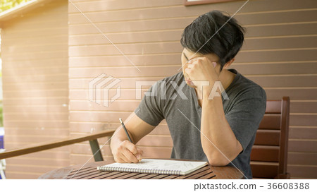 Men writing a book on a balcony. Men writing a book on a balcony. 36608388