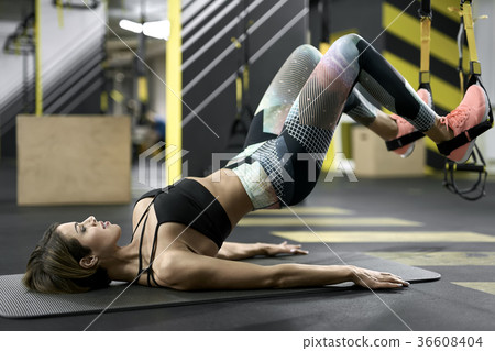 Sportive girl does exercise in gym 36608404