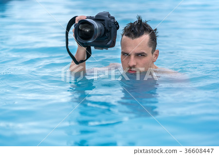Guy relaxing in geothermal pool outdoors 36608447