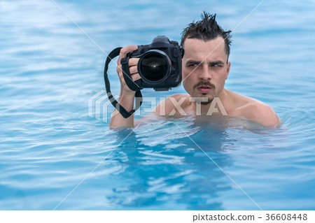 Guy relaxing in geothermal pool outdoors 36608448