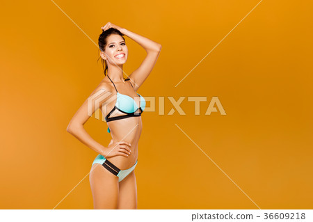 woman in blue bikini on a yellow background 36609218