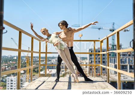 Ballet dancers posing at concrete balcony Ballet dancers posing at concrete balcony 36609250