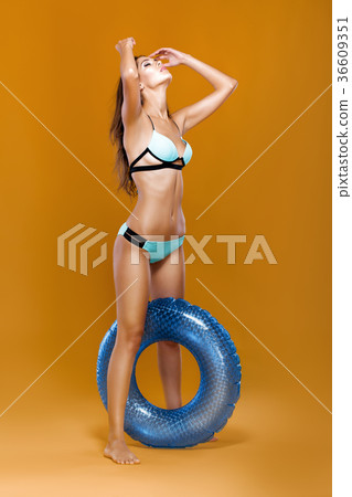 woman in bikini with rubber  ring  woman in bikini with rubber  ring  36609351