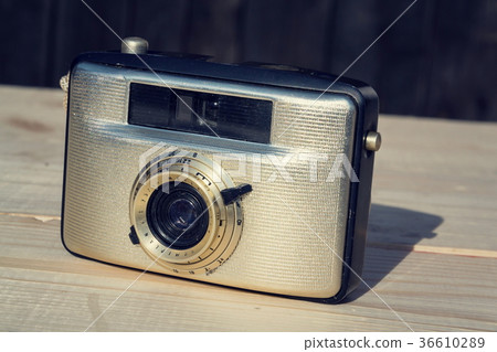 Old vintage golden Penti I camera on wood 36610289