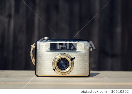 Old vintage golden Penti I camera on wood Old vintage golden Penti I camera on wood 36610292
