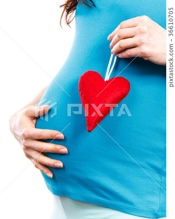 Pregnant woman holding red heart 36610705