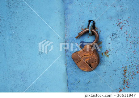 Old rusty lock with a key on a blue background Old rusty lock with a key on a blue background 36611947