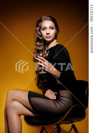 woman holding a glass of champagne woman holding a glass of champagne 36616151