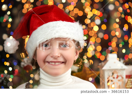 Girl dressed in santa hat with christmas gifts Girl dressed in santa hat with christmas gifts 36616153