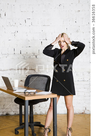 Young blond beauty businesswoman sitting at a Young blond beauty businesswoman sitting at a 36616358