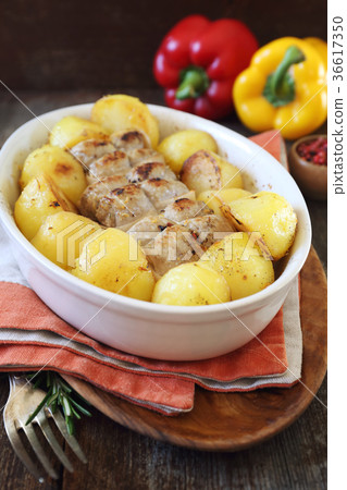 Stewed meat paupiettes with potatoes in bakeware 36617350