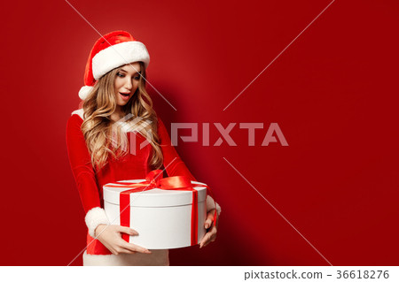 Charming woman in costume posing with present Charming woman in costume posing with present 36618276