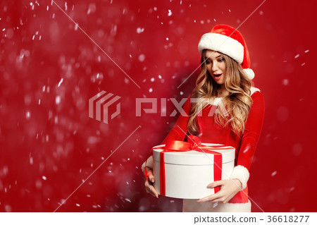 Charming woman in costume posing with present Charming woman in costume posing with present 36618277