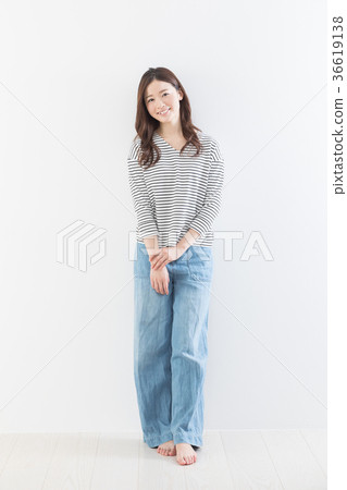 Young woman white wall Young woman white wall 36619138