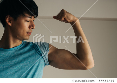 Young Japanese male muscle making a bicep - Stock Photo [36634245] - PIXTA