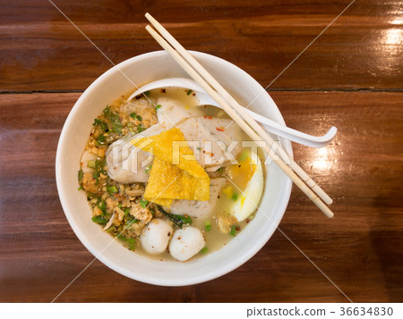 Thai spicy noodle soup on wooden table. Top view Thai spicy noodle soup on wooden table. Top view 36634830