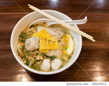 Thai spicy noodle soup on wooden table. Top view Thai spicy noodle soup on wooden table. Top view 36634831