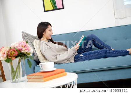 Daily life of a young woman in her 20s lying on the sofa reading a lifestyle 36635511