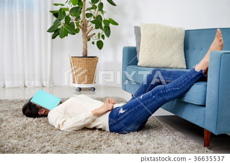 Daily life, life-story work, reading of a young woman who is lying in a carpet and is reading Daily life, life-story work, reading of a young woman who is lying in a carpet and is reading 36635537