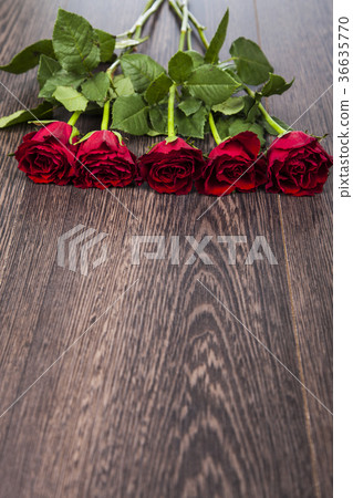 Red roses on a wooden background. Red roses on a wooden background. 36635770