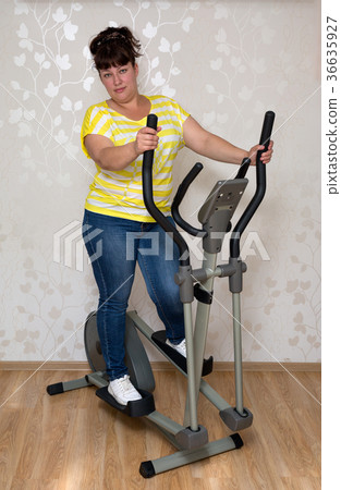 woman exercising on trainer ellipsoid 36635927
