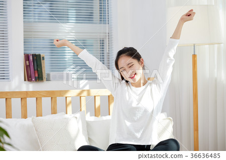 Young woman in twenties stretching in bed. Holiday, lifestyle 36636485