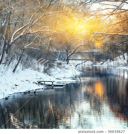 Winter landscape by a river in the sunset 36638627