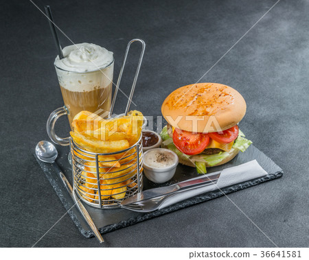 图库照片: left side view on a flame grilled cheeseburger