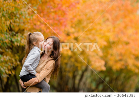 Family of mother and little kid outdoors in park Family of mother and little kid outdoors in park 36642385