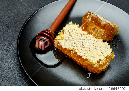 Honeycomb with honey on plate. dark concrete Honeycomb with honey on plate. dark concrete 36642602