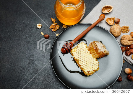 Honeycomb with honey on plate. dark concrete Honeycomb with honey on plate. dark concrete 36642607