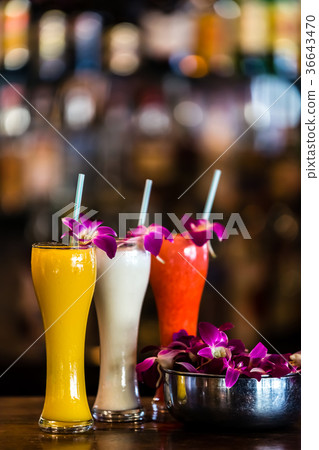 still life with 3 cocktails and orchid flowers 36643470