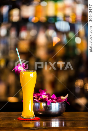 Yellow cocktail with orchid flower in the bar 36643477