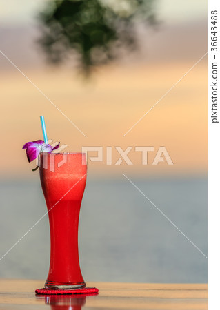 Red cocktail on the beach at sunset. Vertical 36643488