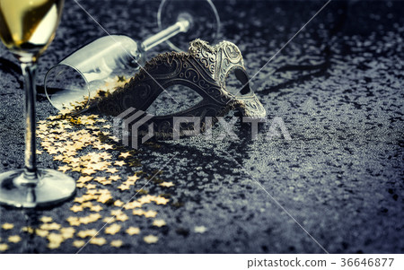 carnival mask and star-shaped confetti with glass 36646877