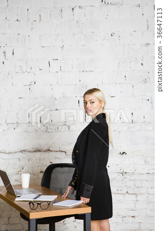 Young blond beauty businesswoman sitting at a 36647113