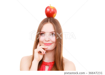 Beautiful woman holds apple fruit on head 36647231