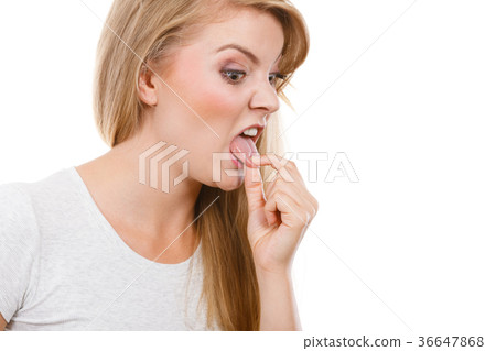 Woman having something disgusting on tongue 36647868