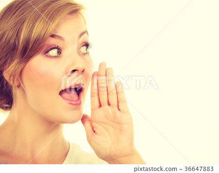 Woman whispering with hand close to mouth 36647883