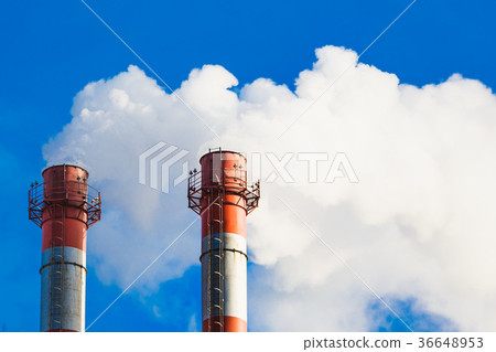 Stream of dark smoke from the chimney of factory 36648953